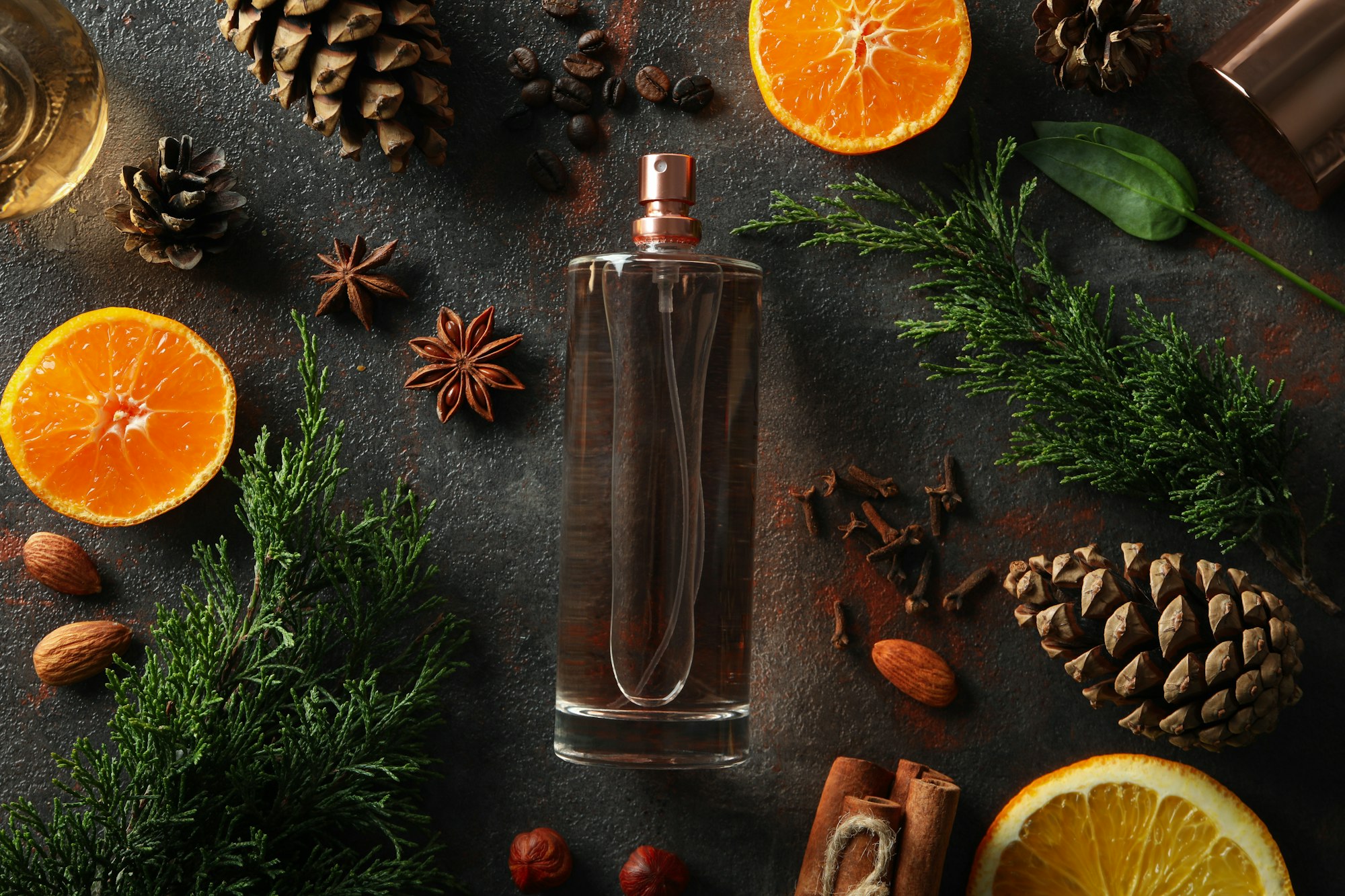Concept of natural perfume on dark textured background